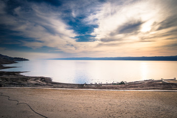 Dead Sea - October 05, 2018: Tourists bathing in the salty Dead Sea, Jordan