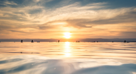 Dead Sea - October 05, 2018: Tourists bathing in the salty Dead Sea by sunset, Jordan