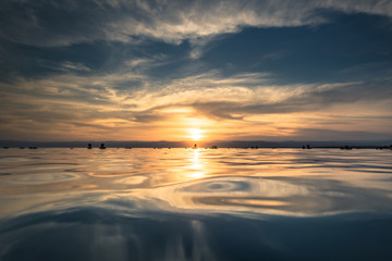 Obraz premium Dead Sea - October 05, 2018: Tourists bathing in the salty Dead Sea by sunset, Jordan