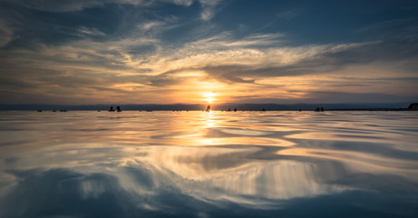 Dead Sea - October 05, 2018: Tourists bathing in the salty Dead Sea by sunset, Jordan