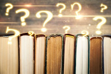 Ancient books in a row on wooden background
