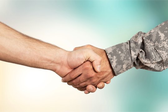 Business Agreement Handshake on background, close up