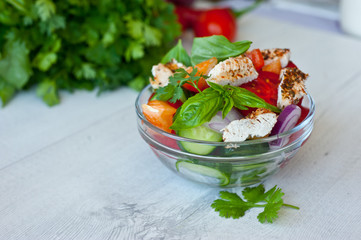 Healthy cooking salad with fresh delicious ingredients and chicken making on cutting board. Diet food.
