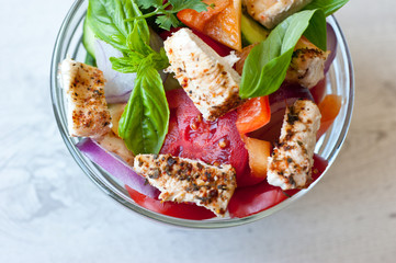 Healthy cooking salad with fresh delicious ingredients and chicken making on cutting board. Diet food.

