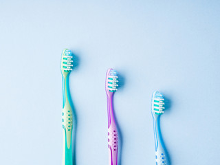 Plastic toothbrushes on blue. Dental hygiene concept