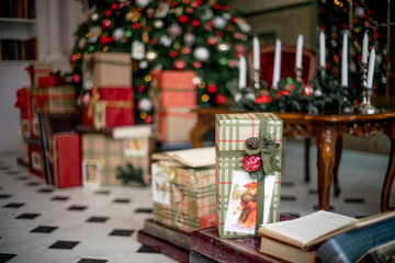 Naklejka na ściany i meble Christmas living room with a christmas tree and presents under it