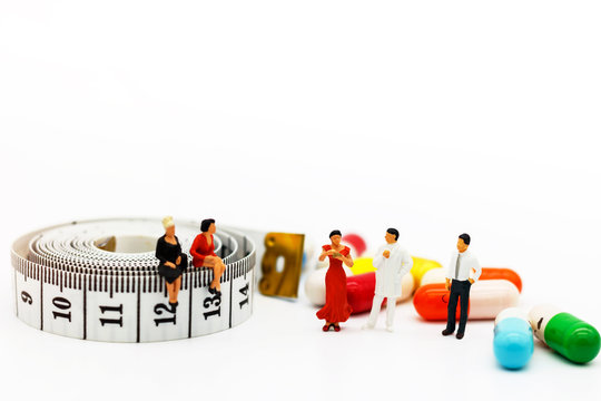 Miniature people: Patients standing with doctor and drugs. Health care and business concept.