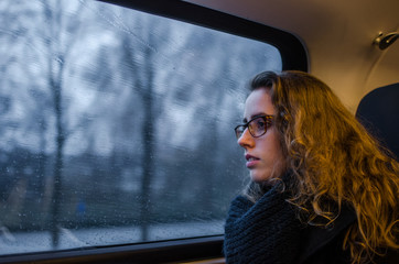 photography portrait of a girl looking in the window of a train.