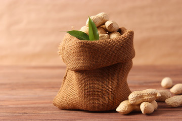 raw peanuts in shell on a wooden background.