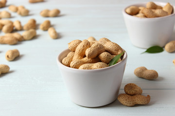 raw peanuts in shell on a wooden background.