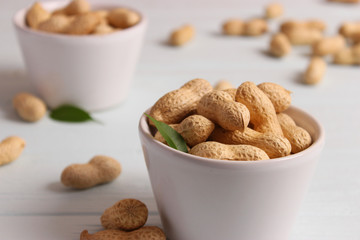 raw peanuts in shell on a wooden background.