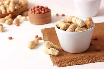 raw peanuts in shell on a wooden background.