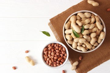 raw peanuts in shell on a wooden background.