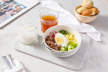 Russian summer soup - okroshka in a plate on the table