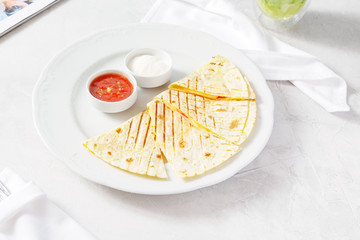 Quesadilla, quesadilla with cheese, meat on a plate on the table