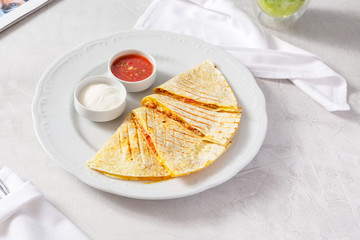 Quesadilla, quesadilla with cheese, meat on a plate on the table