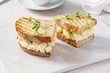 Sandwich with meat and cheese on a plate, breakfast