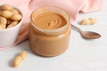  peanut butter and peanut beans on wooden background
