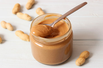  peanut butter and peanut beans on wooden background