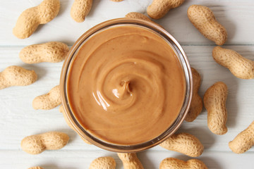  peanut butter and peanut beans on wooden background