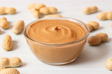  peanut butter and peanut beans on wooden background