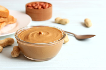  peanut butter and peanut beans on wooden background