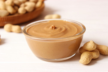  peanut butter and peanut beans on wooden background