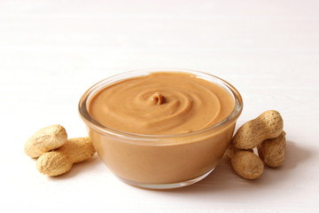  peanut butter and peanut beans on wooden background