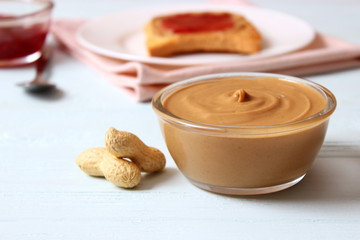  peanut butter and peanut beans on wooden background