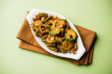 Cooked bitter Melon/gourd or Karela Sabzi served in a bowl. Scientific name of this healthy...