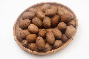 Whole Pecan Nuts in a straw dish