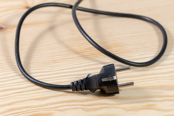 electrical cable with plug on wooden table 