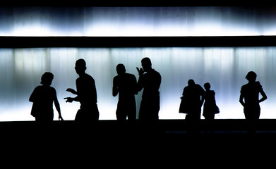 Blurry silhouette of young people  walking in the black and white night