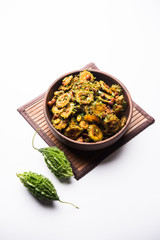 Cooked bitter Melon/gourd or Karela Sabzi served in a bowl. Scientific name of this healthy vegetable is Momordica charantia. selective focus