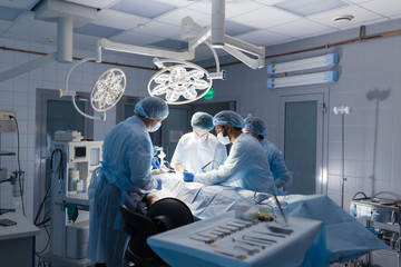 Multiracial Team of Surgeons concentrating on a patient during a heart surgery at a hospital....
