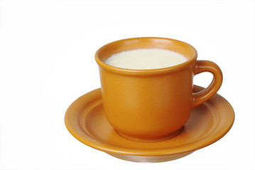 A cup of milk on a saucer and cookie