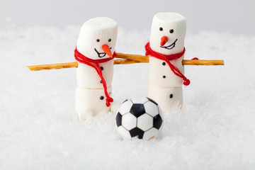 Funny snowman with a soccer ball