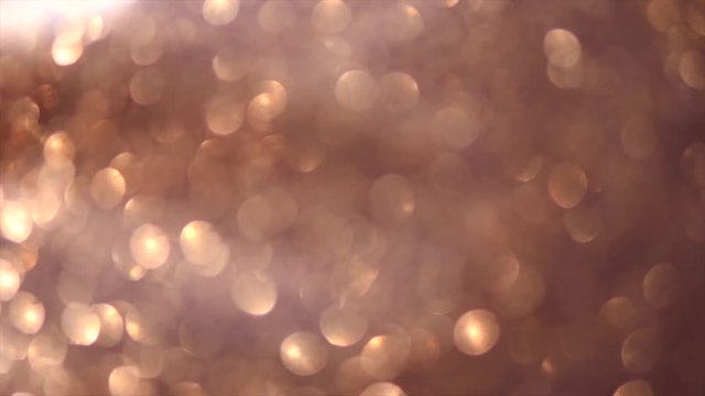 Golden sparkles background. Gold glitter dust backdrop. Holiday bokeh. 3840X2160 4K UHD video footage