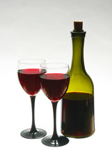 Glasses with red wine and bottle