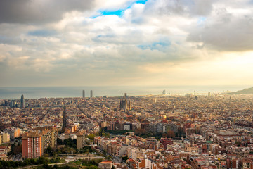 panorama of Barcelona at sunset in the rays of the sun coming out of the clouds