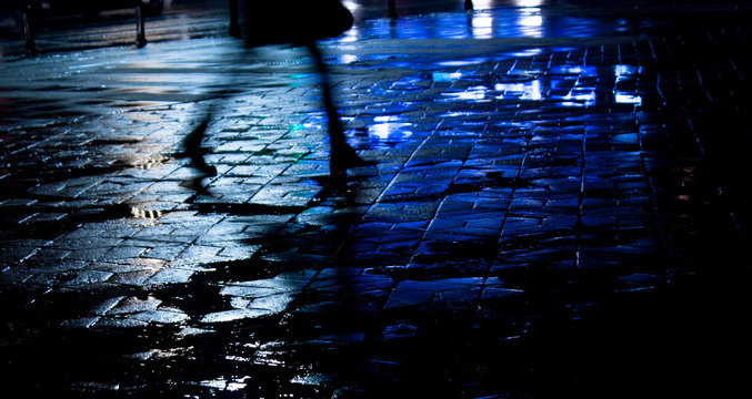 Legs Of A Young Woman Walking In The Night