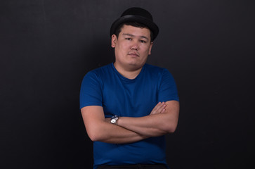 studio portrait of an asian man on a black background