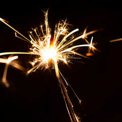 Christmas sparkler isolated on black background. Bengal fire