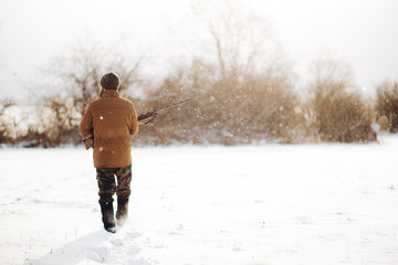 young man is going to hide behind the bushes. back view photo. copy space