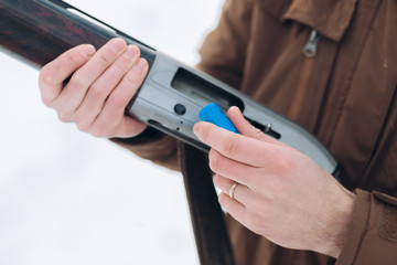 revenge. bullet fo enemy. cruel world. violance. man is testing an old hunting rifle close up cropped photo