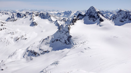Fototapeta na wymiar winter mountain landscape in the Silvretta mountain range in the Swiss Alps with famous Piz Buin mountain peak in the center