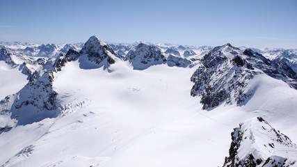 winter mountain landscape in the Silvretta mountain range in the Swiss Alps with famous Piz Buin mountain peak in the center