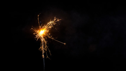 Christmas sparkler isolated on black background. Bengal fire