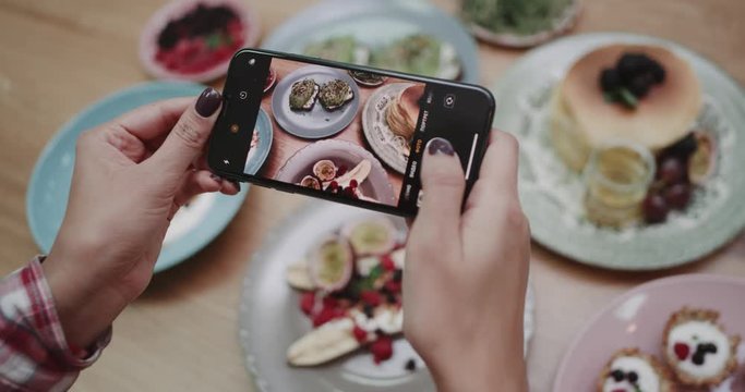 Someone taking pictures of healthy avocado bread and other foods. shot on red epic