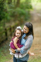 Fototapeta na wymiar Mom holding preschool toddler daughter girl with strong bond and love